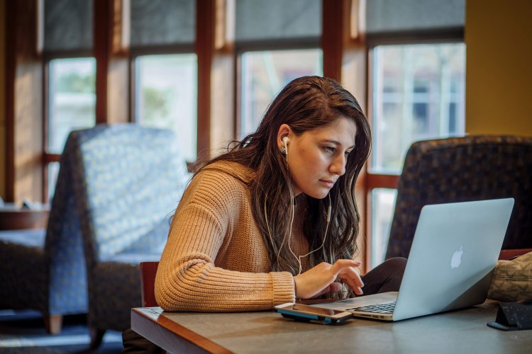 Student working on their laptop in University Hall
