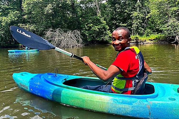 Odera Umeh in a canoe on a lake