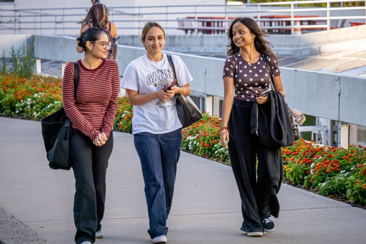 three students walking on campus