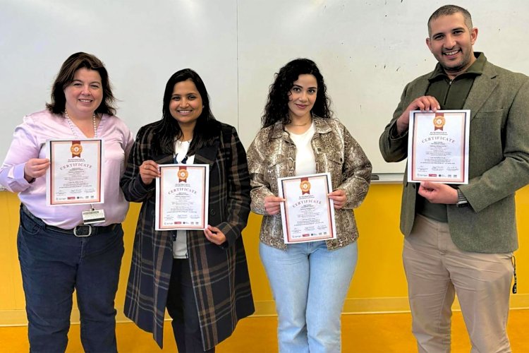 Student team with mentor Dr. Kathy Herbert holding their IEMTRONICS awards