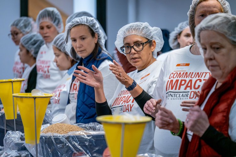 Montclair volunteers get ready to pack up food for children with Rise Against Hunger during Community Impact Day.
