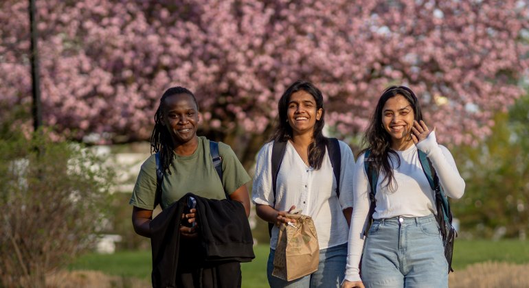 three students walking on campus