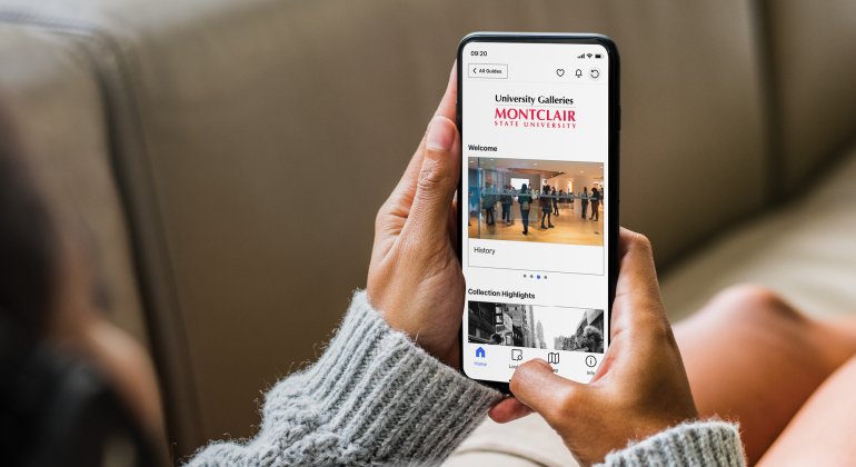 Person looking at their phone with Bloomsberg Connects on the screen
