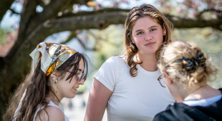 three students talking