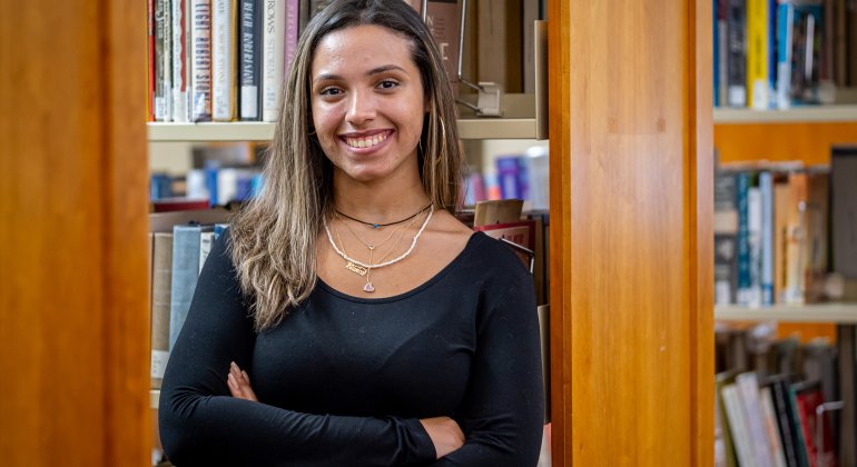 Student smiling in library