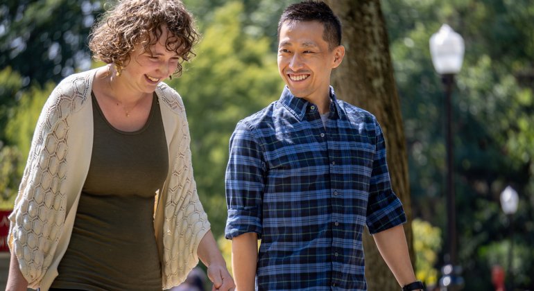 two students walk and talk together