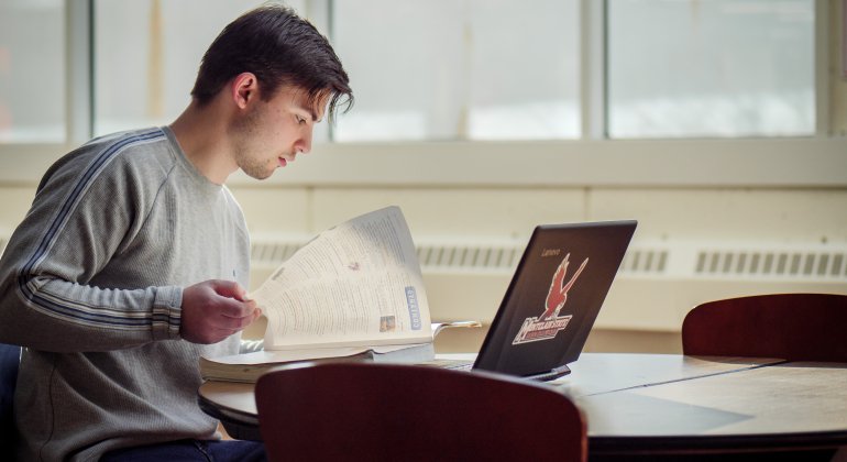a student studies at his laptop