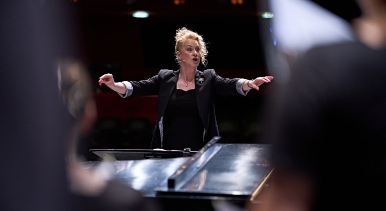 Choir conductor conducting choir