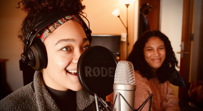 Two Music Therapy students in the Ott Lab in front of Microphone