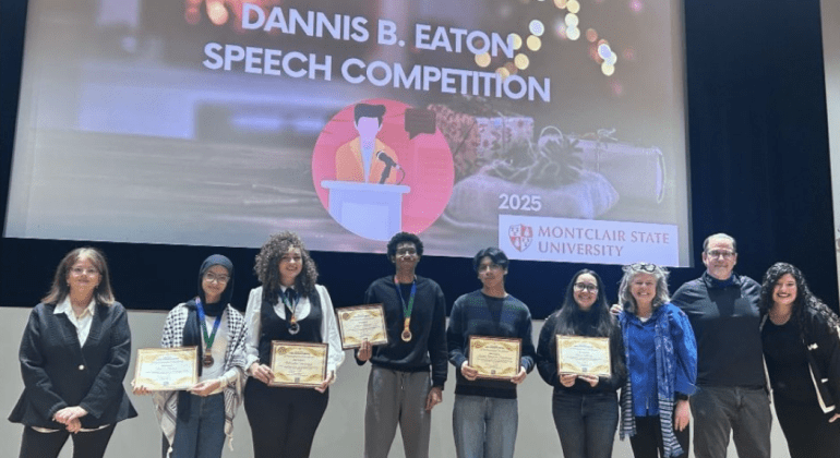 Students posing for photo with faculty after completing the Dannis B. Eaton Speech Competition.