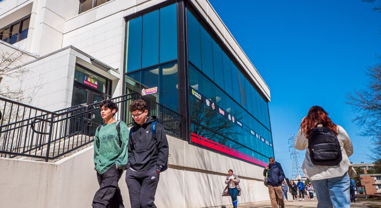 students walking past the student center