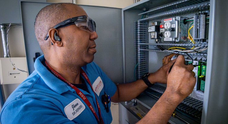 A man working on a utility panel