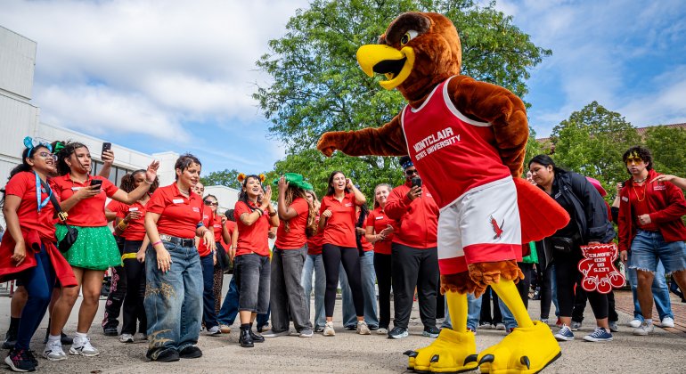 A picture of Rocky dancing with some students at orientation
