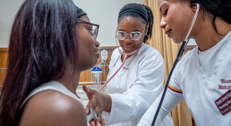 Bloomfield College Nursing students practice bedside manner on a peer mentor of the program.