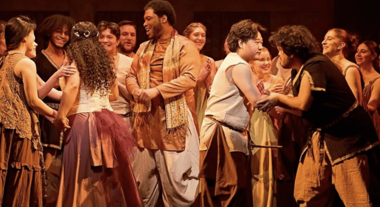 Magic Flute cast on stage dancing and singing in group