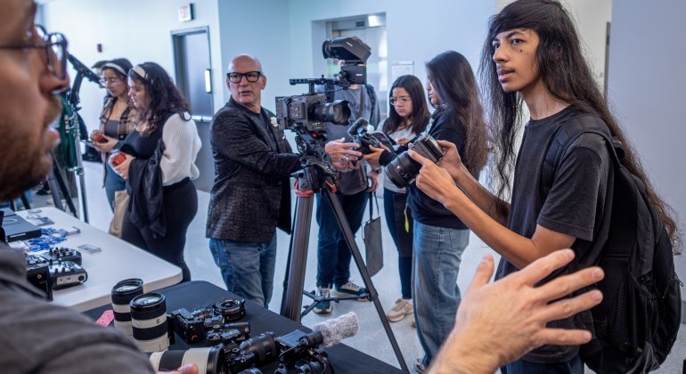 student speaking with industry professionals from Sony camera for the Media Operations Summit and Techspo event