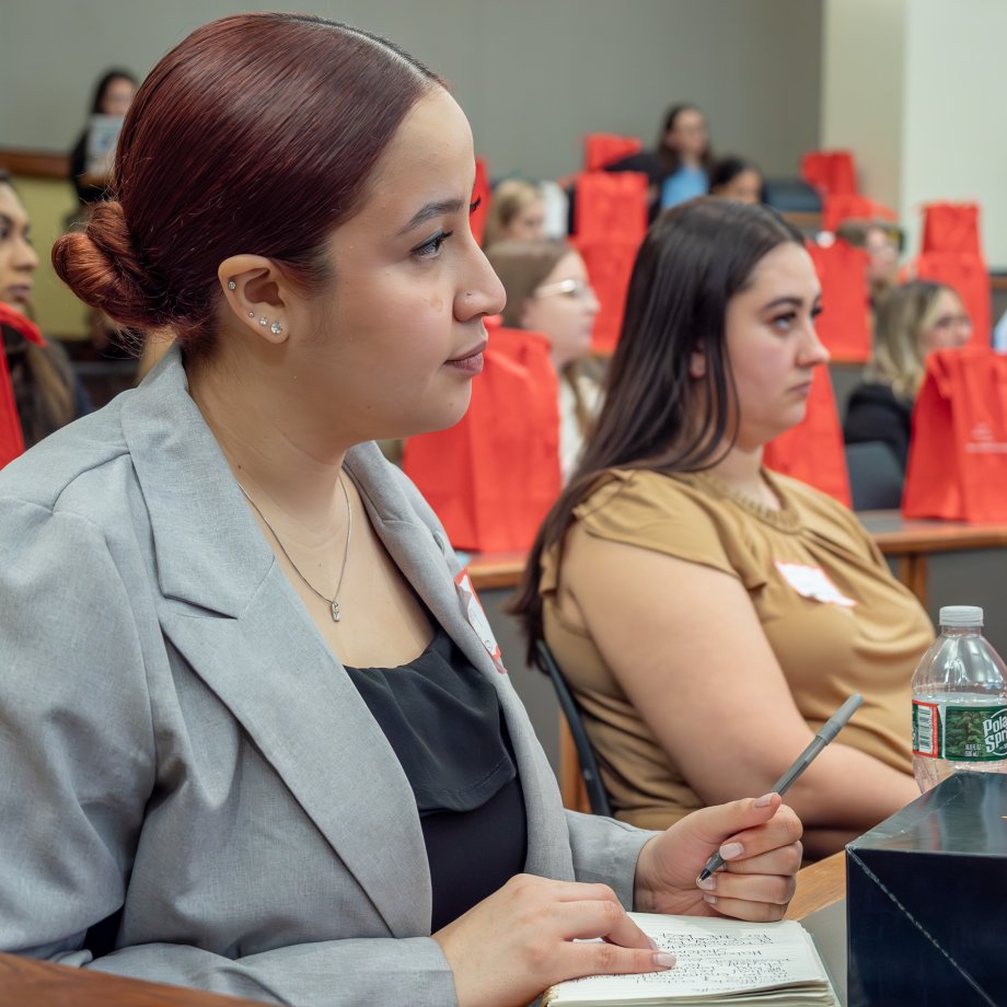 students listen as a speaker talks in a classroom