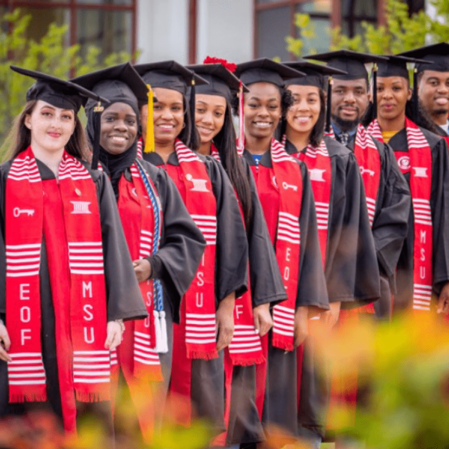 9 graduating educational opportunity fund scholars standing in a line.