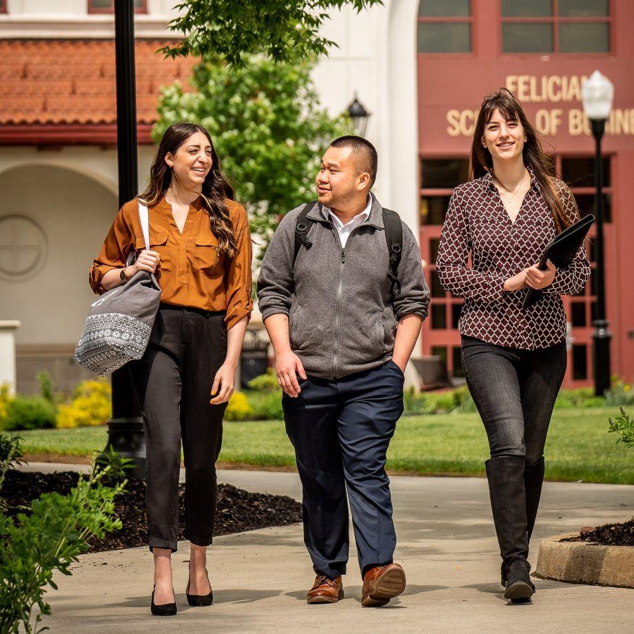 Three students walking on campus