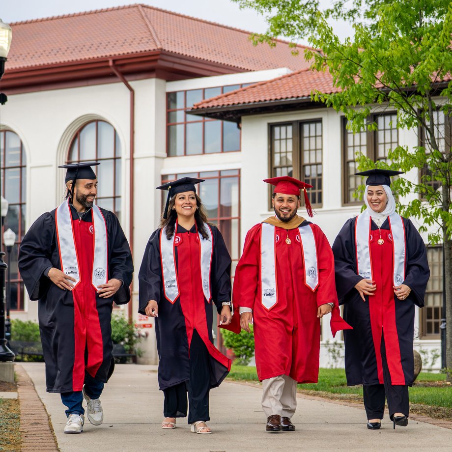 Online degree program graduates in academic regalia