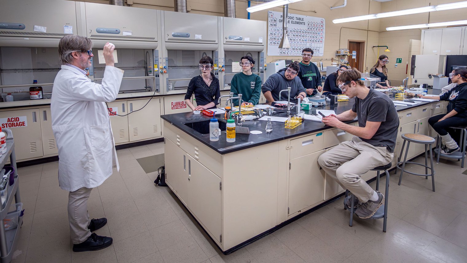 Students listen to Chemistry and Biochemistry Associate Professor David Talaga in the lab.