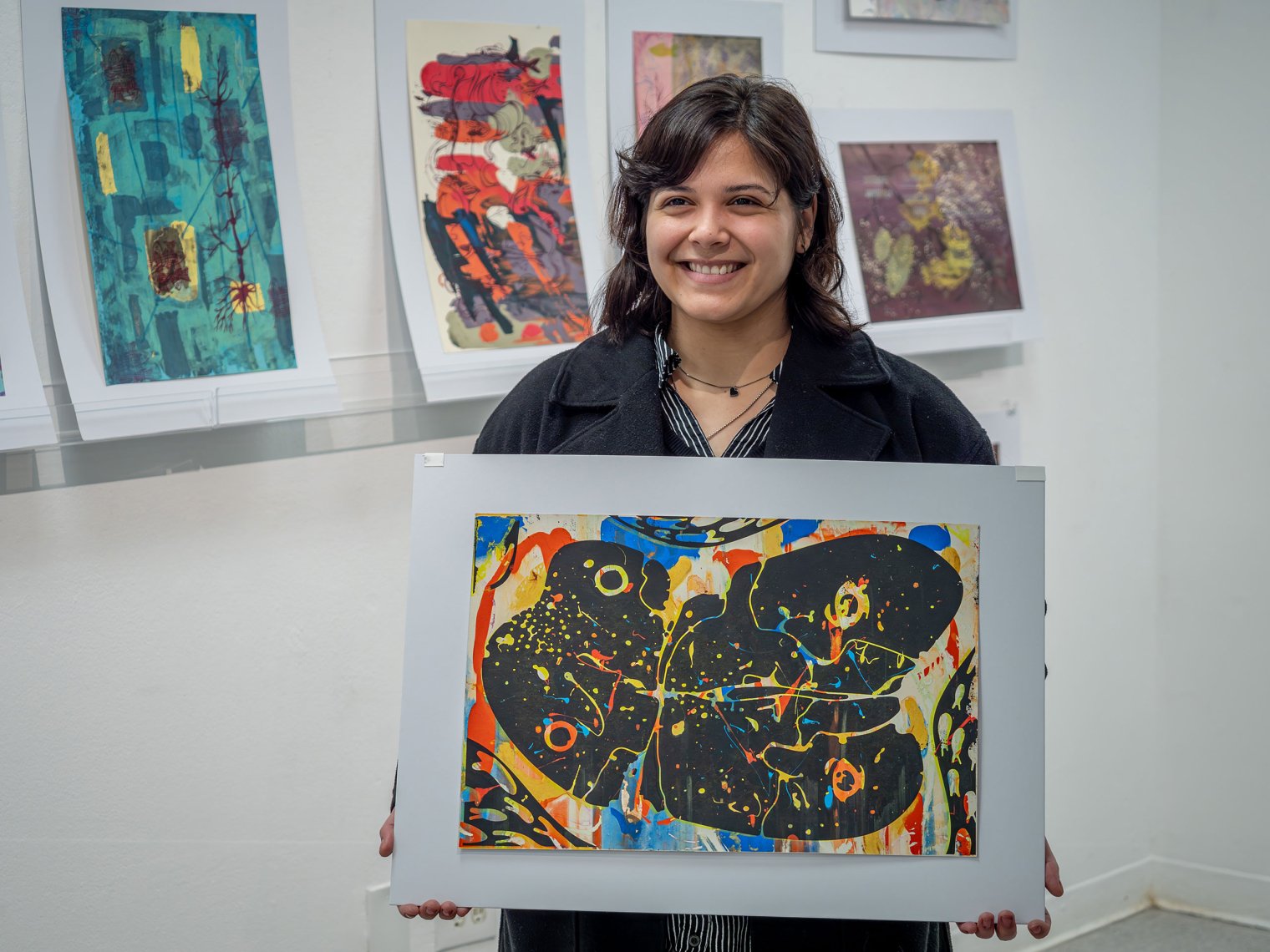Grace Whitaker holds one of her art prints.