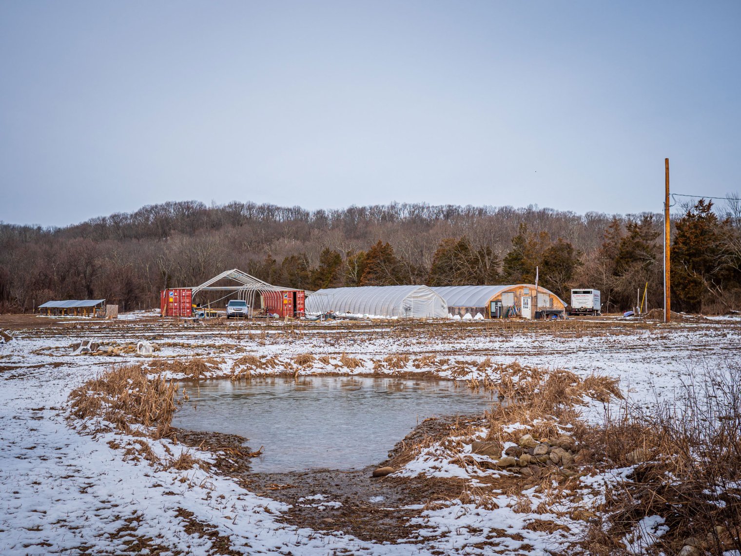 Farm with snow on land.