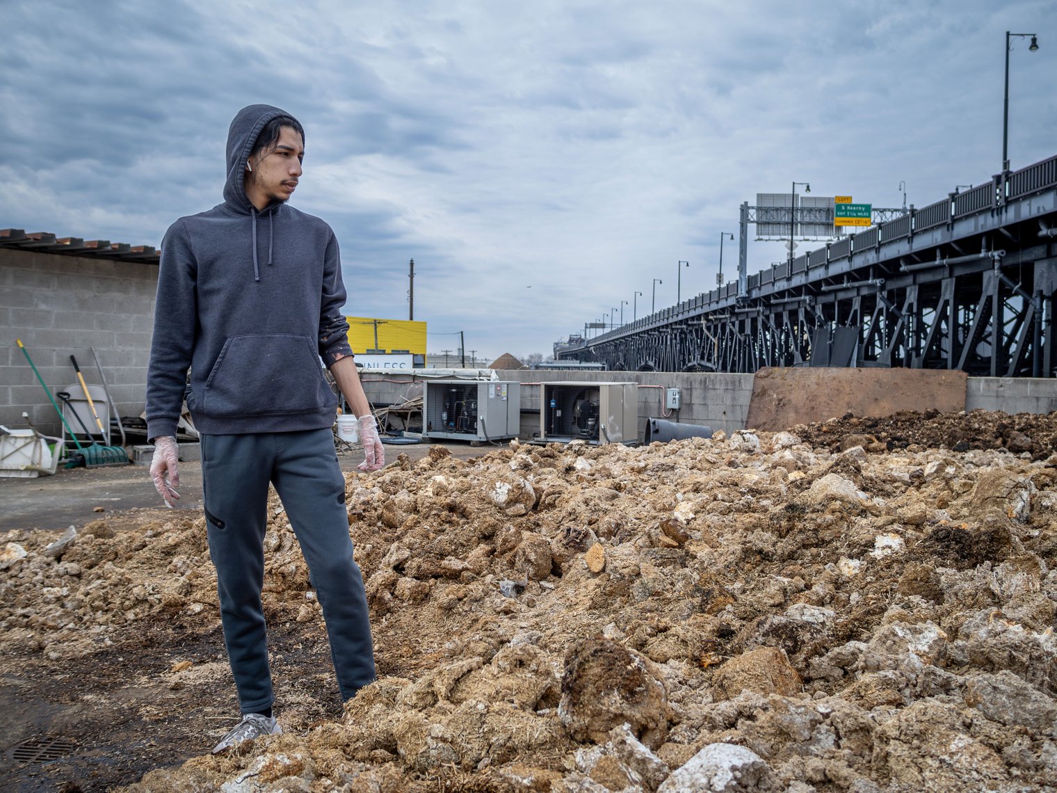 Godek looks out at the rooftop compost pile, where spent mushroom blocks break down into compost available to the community. (Photos by University Photographer Mike Peters)