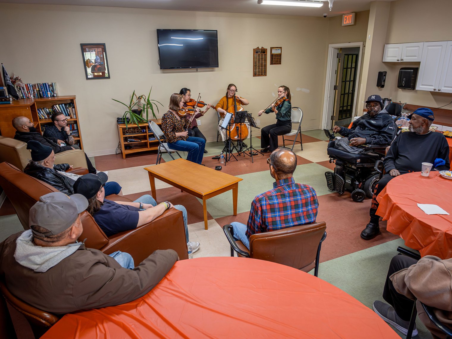 An audience of veterans listen as Trillium plays.