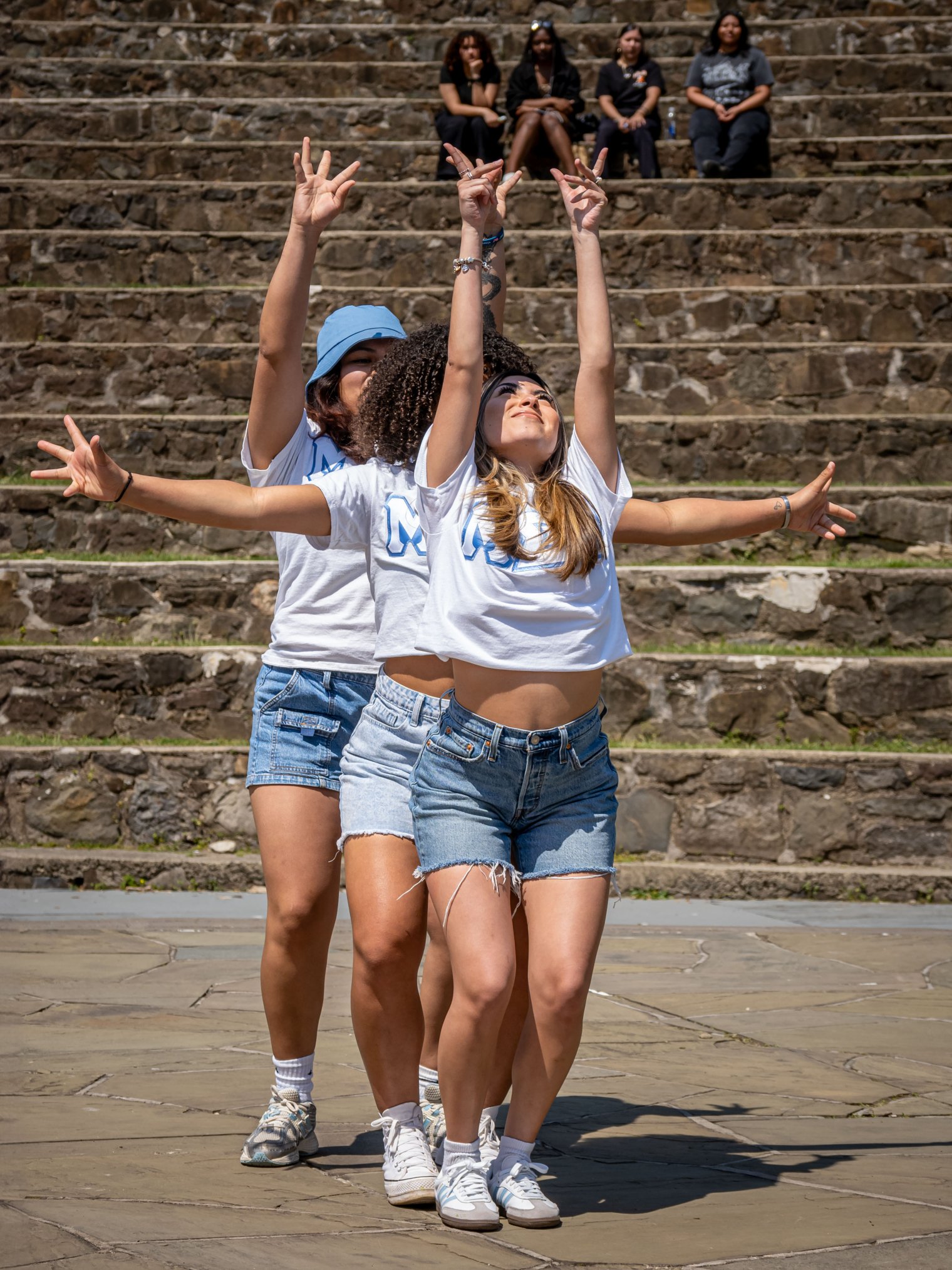 Females in a sorority doing poses.