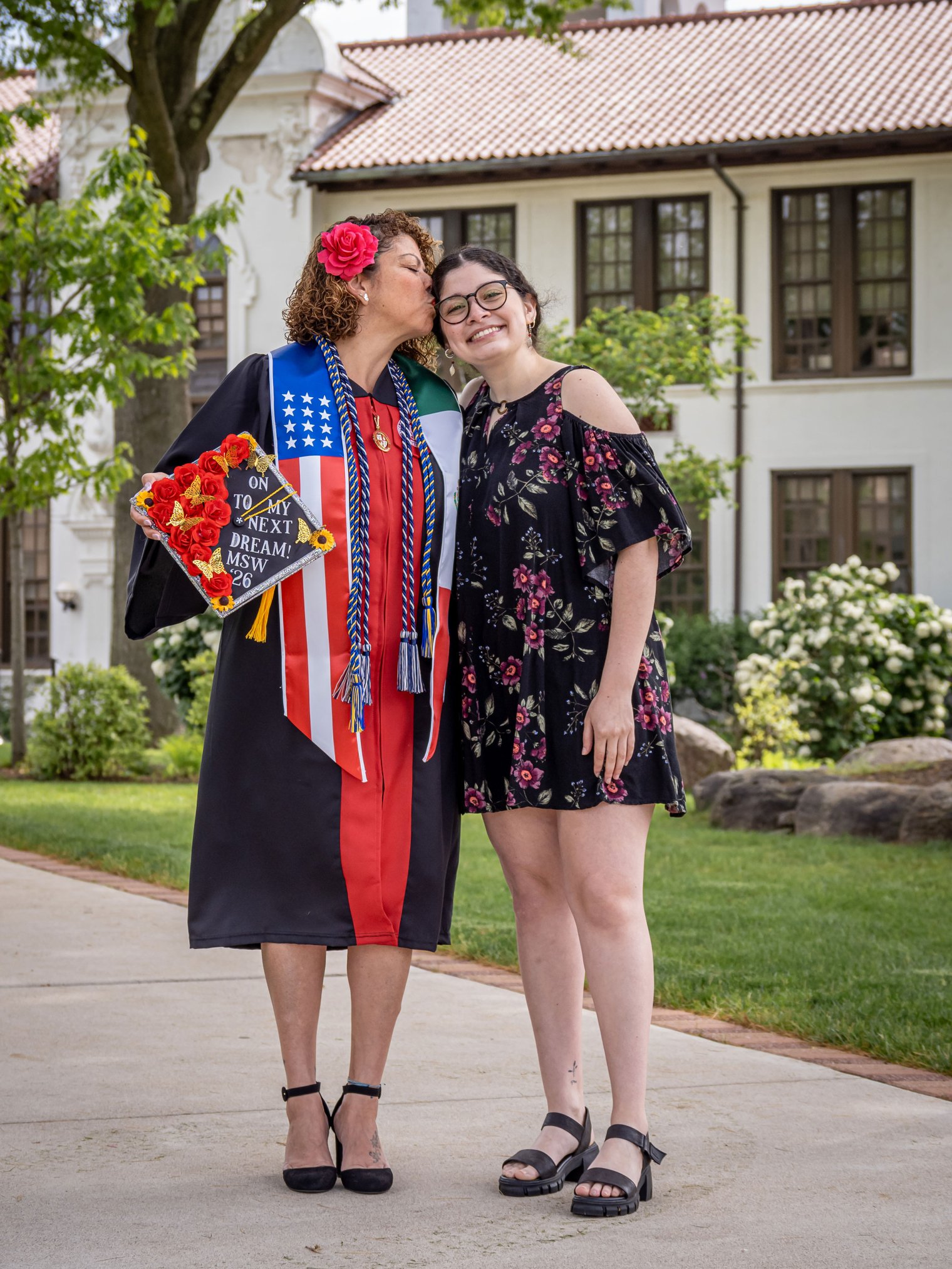 Iliana Woodhull kisses her daughter Angel Bernales on the temple on the Montclair campus.