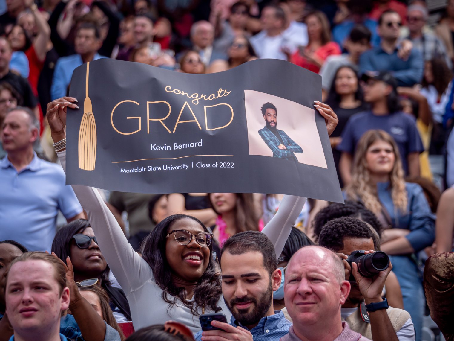 Kiana Bernard holding a sign for Kevin Bernard