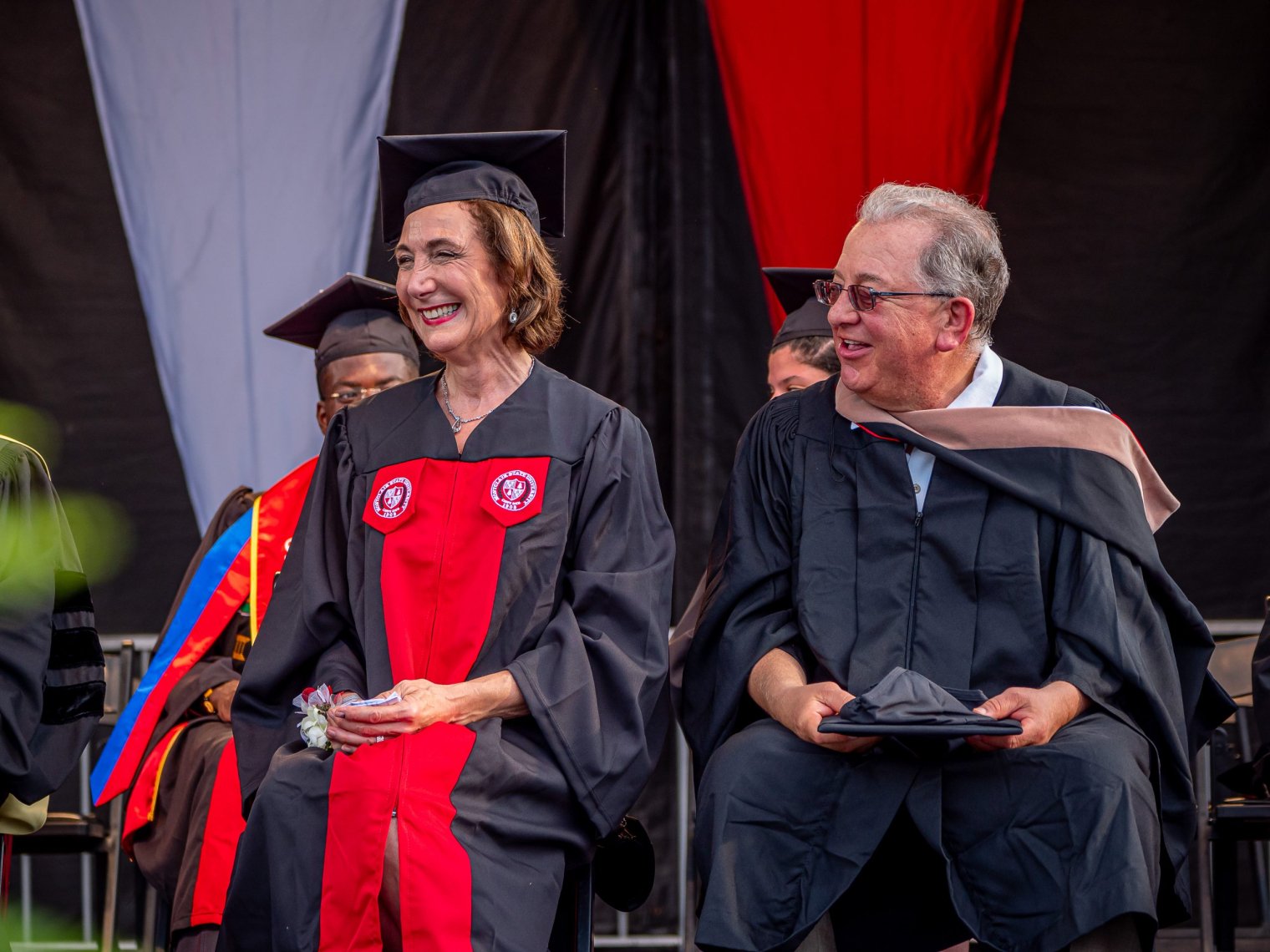 Honorary degree recipient Mimi Feliciano on the platform with her husband, Edward.