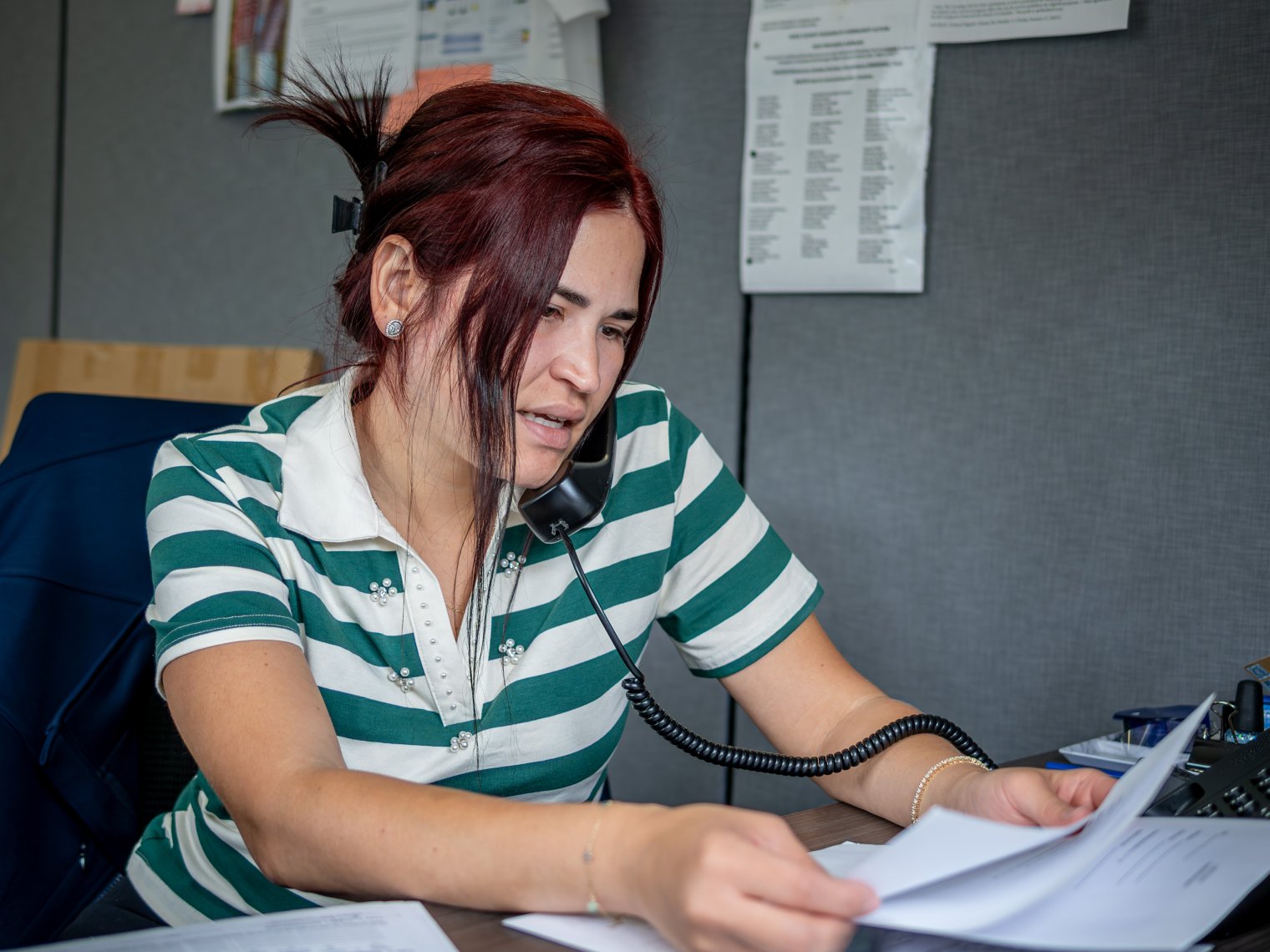 Oscaterin fields calls and reviews paperwork in her office at the Montclair Child Development Center.