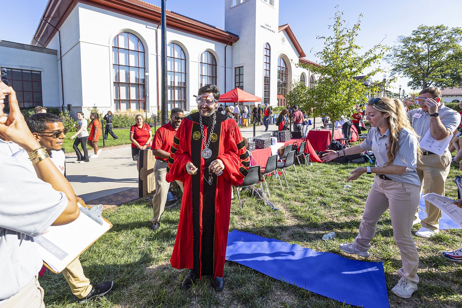 President Koppell wears goggles and poses for photograph