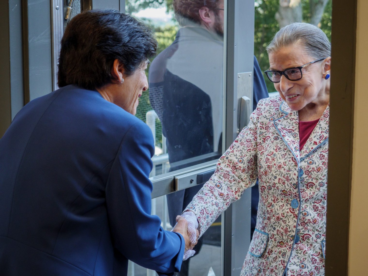 Ruth shaking hands with another women.