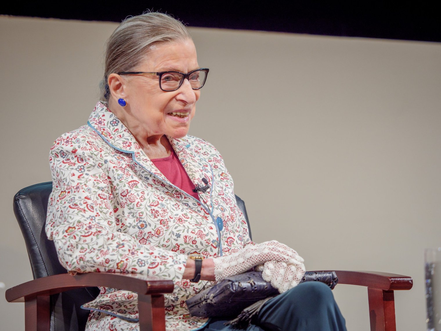 Ruth smiling while sitting down.