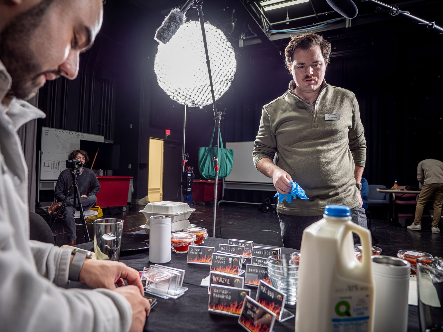 Two young men prepare the set.