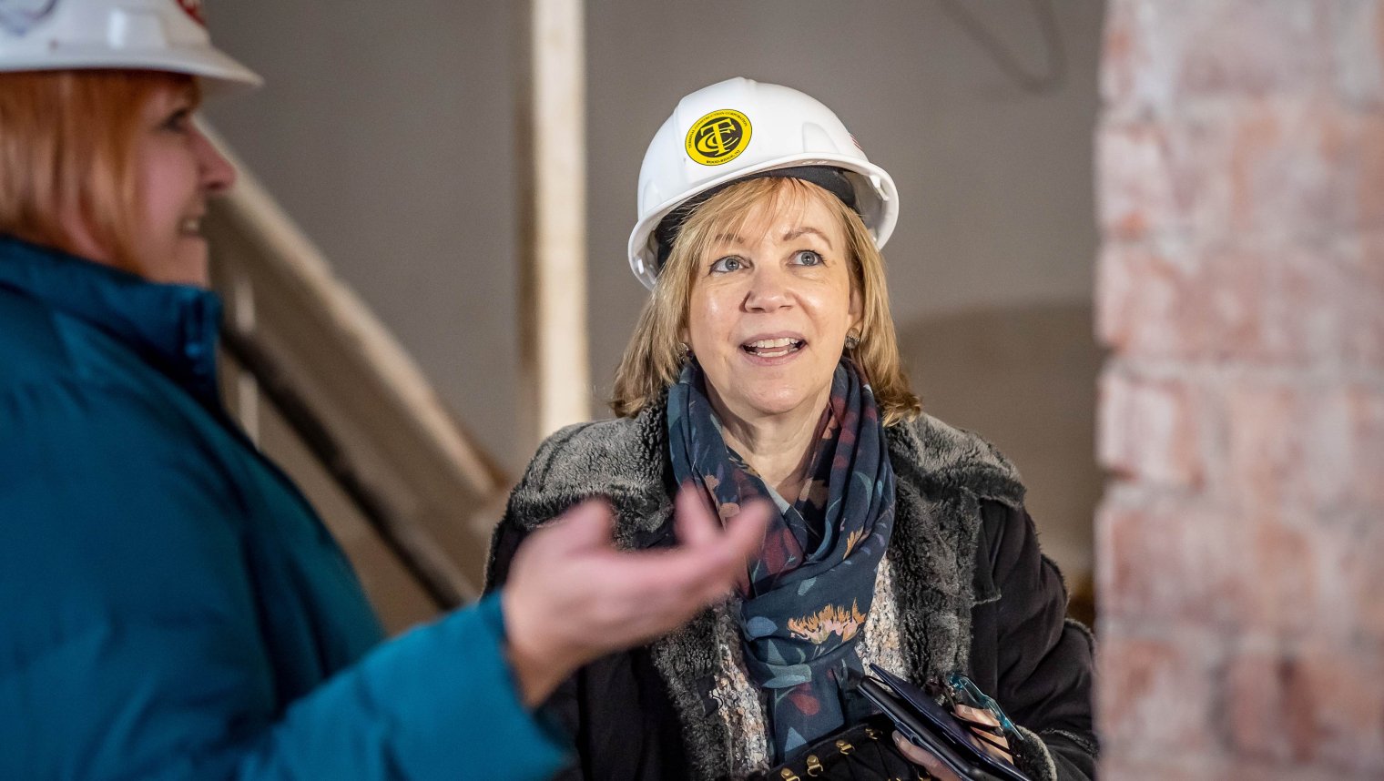 Lorraine Arnold ’11, a buildings archaeologist/ genealogist, returned to her alma mater to see first-hand the College Hall renovations and to assist in the search for descendants of the bricklayers. She’s shown with Sharon Mahoney, the University’s director of construction management.