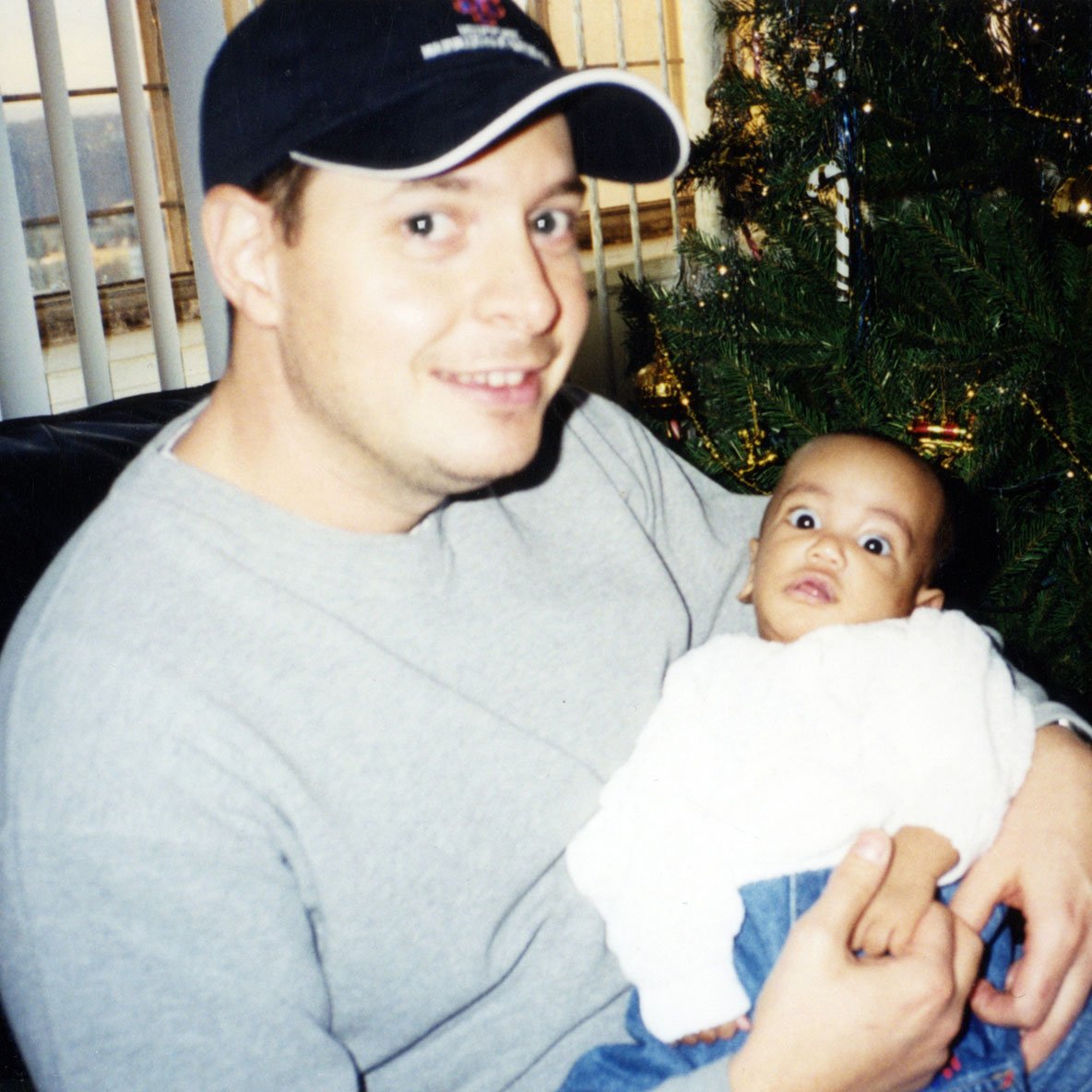 Peter Mercurio cradling Kevin as an infant