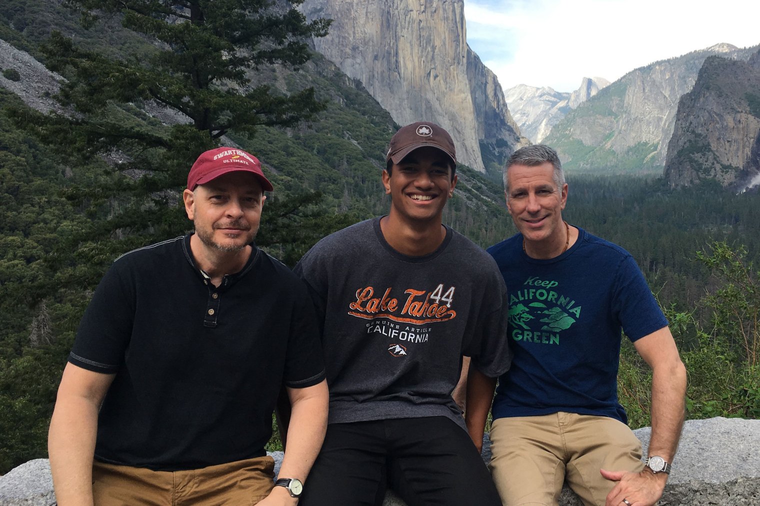 Family photo at scenic overlook in Yosemite Park with El Capitan in the distance