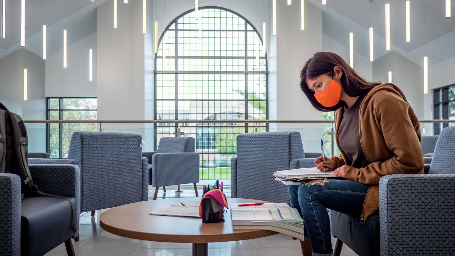 student working on homework in the new atrium after completion