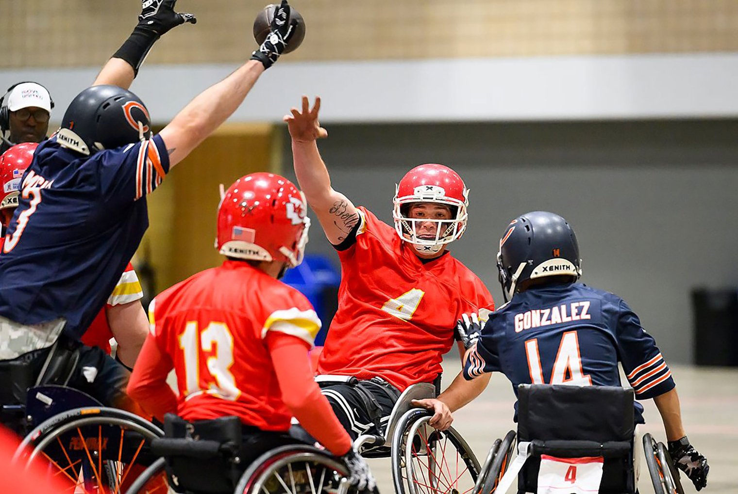 A USA Wheelchair Football League player throws a pass.