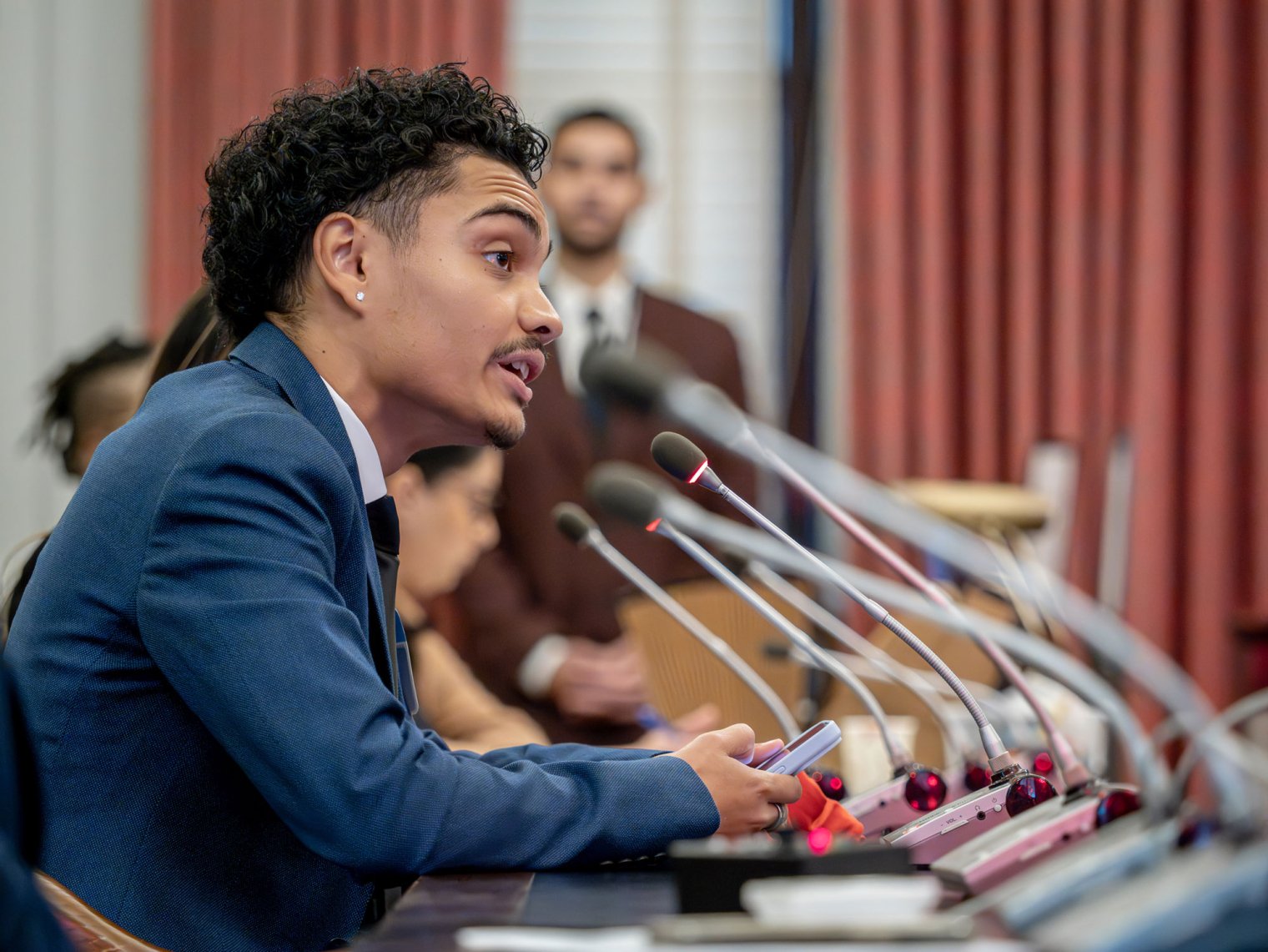 A student speaks to a committee at the New Jersey State Capitol.