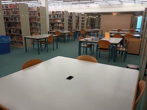 A large study space with several desks and chairs