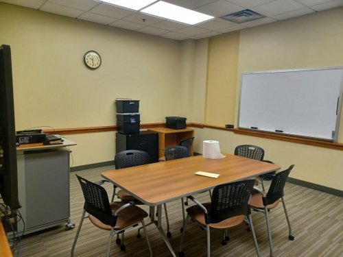 Study room with table, chairs, and whiteboard