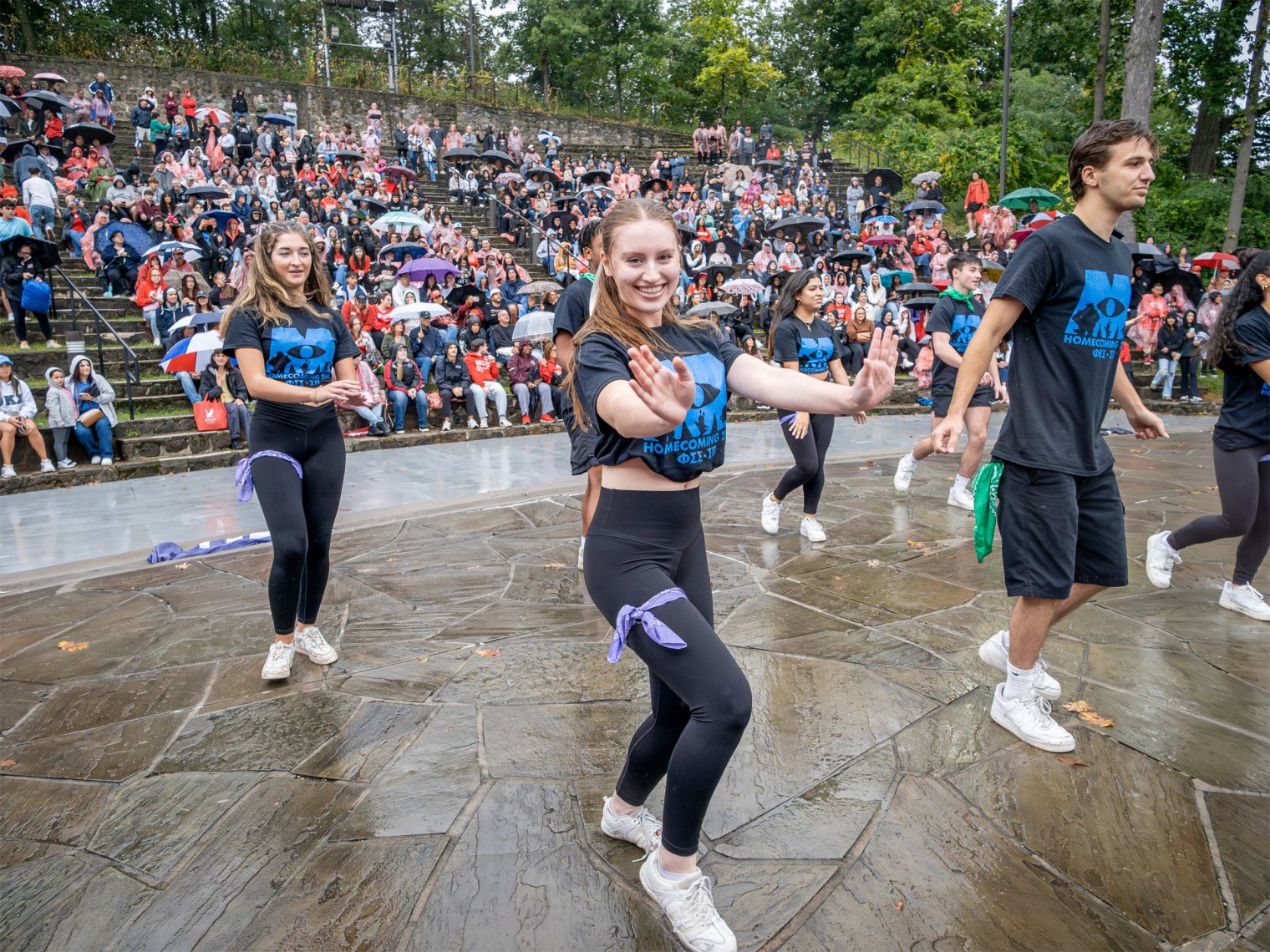 Group of students dancing in front of a crowd.