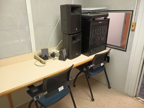 Listening room with a table, chairs, amps, and record player