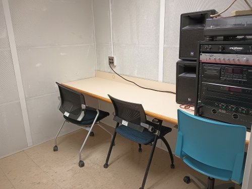 Listening room with a table, chairs, amps, and record player