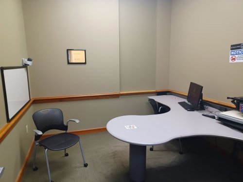 study room with table, chairs and whiteboard